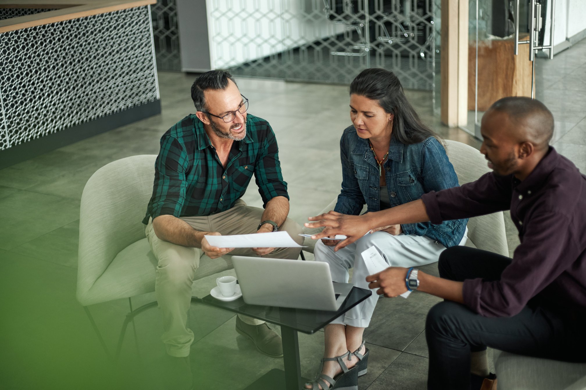 Casual meeting of diverse business team analyzing financial data